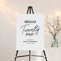 a white sign with the words hello twenty one on it in front of some lights