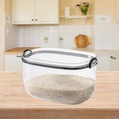 a glass bowl filled with sand on top of a wooden counter