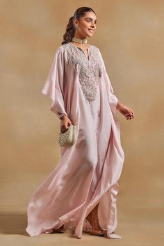 Baby pink kaftan, highlighted with beads, crystal embellished yoke and chantilly lace detailing.
Components: 1
Pattern: Embellished
Type Of Work:  Beads, Crystals
Neckline: Notched Neck
Sleeve Type: Three Quarter Sleeves
Fabric: Habutai Silk, Chantilly Lace
Color: Pink
Other Details: 
Model height: 5ft 8inches, wearing size M
Note: The bag shown in the image is not for sale

Occasion: Sangeet - Aza Fashions Latest Kaftan Designs, Pink Kaftan, Kaftan Pattern, Kaftan For Women, Kaftan Designs, Muslim Couple Photography, Silk Kaftan, Designer Party Wear Dresses, Indian Clothes