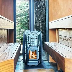 a wood burning stove sitting inside of a wooden room