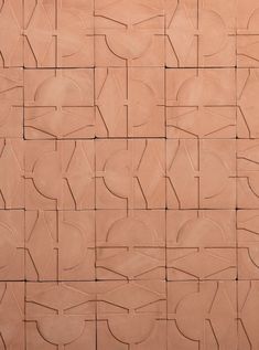 a close up view of a wall made out of tiles with different shapes and sizes