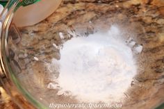 a glass bowl filled with white liquid on top of a counter