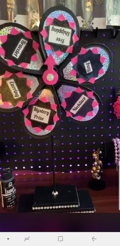 there is a display with pink and black flowers on it, along with other decorations