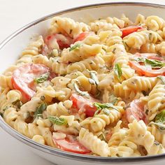 a white bowl filled with pasta salad on top of a table