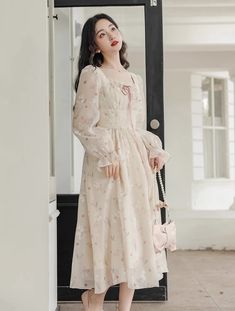 Lightweight silky chiffon printed midi dress with a square neckline, long sheer puff sleeves, tie-up lace neck and laced waistline. Concealed back zipper. Lined. S: 33" chest, 26.5" waist, 43" lengthM: 34.5" chest, 28" waist, 43" lengthL: 36" chest, 29.5" waist, 43.5" lengthXL: 37.5" chest, 31" waist, 43.5" length Cream Lantern Sleeve Dresses For Spring, Feminine Chiffon Dress With Square Neck, Spring Chiffon Dress With Sheer Long Sleeves, Beige Lantern Sleeve Dress For Spring, Spring Chiffon Midi Dress With Square Neck, Feminine Chiffon Midi Dress For Daywear, Spring Square Neck Chiffon Midi Dress, Chiffon Midi Dress With Square Neck, Flowy Square Neck Chiffon Dress