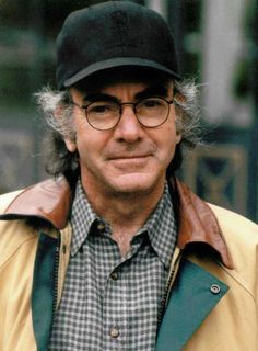 an older man wearing glasses and a hat