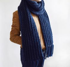 a woman wearing a blue knitted scarf