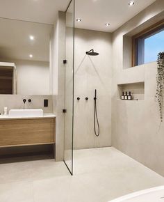 a bathroom with a walk in shower next to a sink