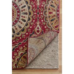 an area rug with red and gold designs on it