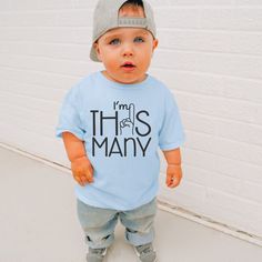 "Get ready to celebrate that special milestone with our \"I'm This Many\" boys t-shirt!  Featuring a playful design with a hand holding up a finger to represent the number 1, its perfect for your little one's first birthday or cake smash outfit.  Made from soft fabric, it's not just adorable but also practical for all day wear.   Let your little guy shine in style on his big day with this adorable t-shirt! These t-shirts are mostly Gildan, Bella, or Rabbit Skins." Fun Blue Top For First Birthday, Cute T-shirt For First Birthday And Father's Day, Cute T-shirt For First Birthday On Father's Day, Baby Boys First Birthday, Boys First Birthday, 1st Birthday Shirt, First Birthday Shirt, Outfit Retro, Baby Boy First Birthday