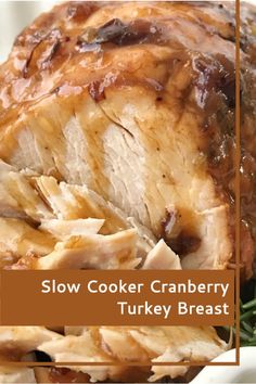 slow cooker cranberry turkey breast on a white platter with rosemary sprigs