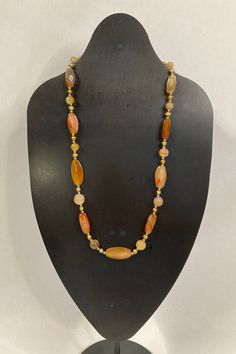 #BC-39 Handcrafted by one of our local artists, this necklace is made of Carnelian beads and Freshwater Pearls. It has a soft color palette with light pinks, browns, golds, yellows, and more.  Carnelian known as the artist's stone. It represents courage and vitality. Freshwater Pearls are known for virtue, inner beauty, and loyalty. - Gemstone : Carnelian - Gemstone : Freshwater Pearls - Metal : Sterling Silver - Toggle Closure - Pendant Length : 21.5" with clasp.  Measurement is an approximation. Luxury Handmade Carnelian Beaded Necklaces, Gold Hand-strung Agate Necklace, Gold Single Strand Agate Necklace, Gold Agate Single Strand Beaded Necklace, Gold Carnelian Beaded Necklaces For Healing, Gold Carnelian Beaded Necklace For Healing, Brown Carnelian Gemstone Beads Necklace, Brown Necklaces With Polished Oval Beads, Brown Agate Necklaces With Polished Beads