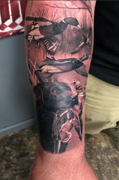 a man's arm with birds on it