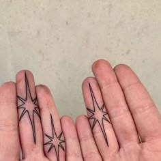 two fingers with small stars on them