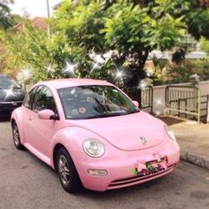 a pink car is parked on the street