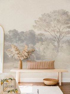 a room with a bench, mirror and wallpaper