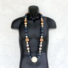 This amazing wood beaded necklace was handmade using a bohemian mix of large 24mm round distressed wooden beads in gray, navy blue, and tan, cream ceramic square beads, a variety of small wooden beads and a MAJOR 50mm round beige ceramic focal bead. This is definitely one of the most special necklaces that I've ever made! The necklace measures approximately 48 inches in length and is securely fastened with a sterling silver toggle clasp. Perfect for any gender! Length can be adjusted if needed - Rustic Wooden Beads Necklaces, Rustic Wooden Beads Necklace, Special Necklaces, Unique Mens Necklace, Everyday Pendant, Ceramic Square, Beige Ceramic, Necklace Mens, Mens Necklace