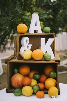 the fruit is stacked on top of each other and placed in front of the letters