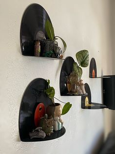 three wall mounted shelves with plants and other items on them in the shape of hearts