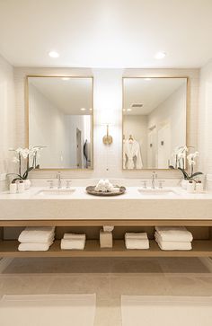 a bathroom with a sink, mirror and bathtub in the middle of it's room