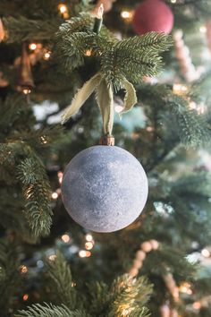 an ornament hanging from the top of a christmas tree