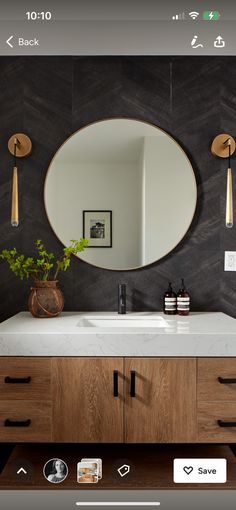 a bathroom with a mirror, sink and wooden cabinetry in it's center