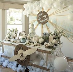 a table with balloons and decorations on it