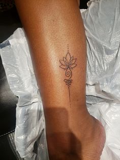 a woman's foot with a tattoo on it and a flower in the middle