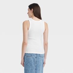 This Ribbed Tank Top from Universal Thread™ in a solid color makes a versatile wardrobe staple. Fashioned in a fitted silhouette, it features a U-neck and a ribbed construction for a textured look. The soft cotton fabric with a hint of spandex offers stretchy comfort, while the pullover style makes for easy wear. Coordinate with a range of bottoms and layering pieces for versatile styling. Universal Thread™: The denim collection that's true to you. Everyday Fitted Ribbed Tank Top, Classic Ribbed Tank Top For Spring, Trendy Fitted Tank Top With Ribbed Neckline, Fitted Ribbed Tops For Everyday, Basic Fitted Ribbed Tank Top, Fitted Solid Color Tops With Ribbing, Basic Ribbed Fitted Tank Top, Fitted Ribbed Tops For Spring, Fitted Solid Color Ribbed Tops