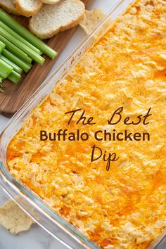 the best buffalo chicken dip in a casserole dish with bread and celery