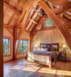 an attic bedroom with wooden walls and flooring