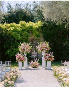 an outdoor ceremony setup with flowers and chairs