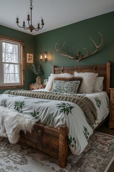 a bed room with a neatly made bed and a deer head mounted to the wall