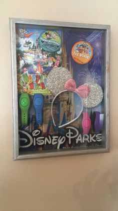 the disney parks poster is hanging on the wall