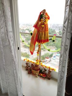 a statue is sitting on the window sill