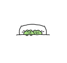 two little green frogs sitting in the middle of a bed