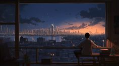 a man sitting at a table looking out over a cityscape from a window