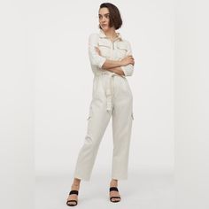 Jumpsuit In Cotton Denim With A Soft, Brushed Finish. Collar, Concealed Zipper At Front, And Yoke At Back. 3/4-Length Sleeves, Chest Pockets With Flap, And Tapered Waist With Attached Tie Belt At Front. Tapered Legs And Leg Pockets With Flap. Color Is Listed As White More Of A Cream/Off White Color. Denim Boiler Suit, H&m Brand, Jumpsuit White, Boiler Suit, White Jumpsuit, Long Style, M Pants, Off White Color, Denim Jumpsuit