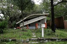 a house in the middle of some trees and grass