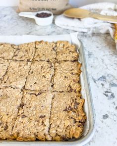 a pan filled with oatmeal bars sitting on top of a counter