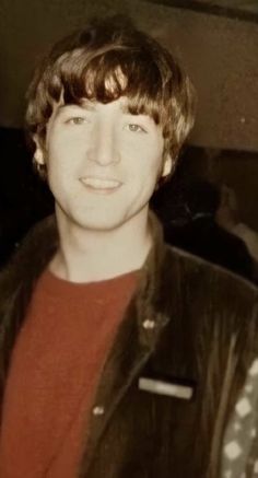 an old photo of a young man in a leather jacket smiling at the camera and then looking into the camera