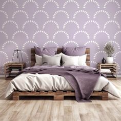 a large bed sitting in front of a purple wall with white circles on it's headboard