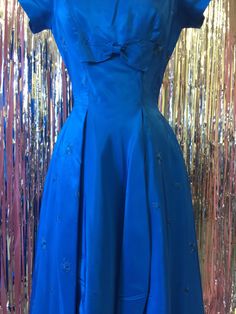 Perfect deep royal blue cocktail dress. Cinch yourself up in your favorite bustier and serve some champagne to your guests. Perfect for a New Years party, a holiday party, or any special occasion year round you can dream up! Thick shiny royal blue satin. Deep enough to hide a party stain or two! bust 32" waist 24" hips 38" 39" long Royal Blue Ball Gown Evening Dress For Party, Party Evening Dress With Pleated Bodice, Tea Length, Pleated Bodice Tea-length Evening Dress For Party, Pleated Bodice Tea Length Evening Dress For Party, Tea Length Evening Dress For Cocktail And Prom, Tea-length Evening Dress For Cocktail Prom, Royal Blue Satin Prom Evening Dress, Royal Blue Satin Evening Dress For Prom Season, Royal Blue Satin Evening Dress For Party