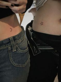 two women with small tattoos on their stomachs