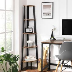 a desk with a computer, chair and bookshelf in front of a window