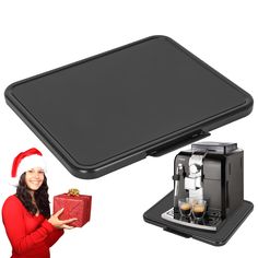 a woman holding a christmas present next to an espresso machine with santa's hat on