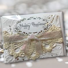 a white card with a pink bow on it