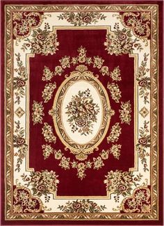 a red and white rug with an ornate design on the center, surrounded by leaves