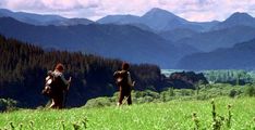 two people are hiking in the mountains with backpacks