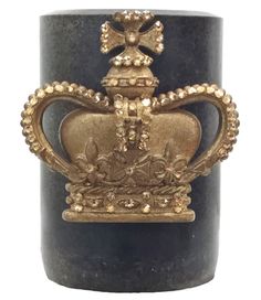 a black candle with a gold crown on it